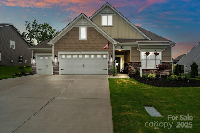 17733 Burnt Hickory Dr, Charlotte, NC 28278 - craftsman-style house with board and batten siding, a garage, concrete driveway, a front lawn, and stone siding