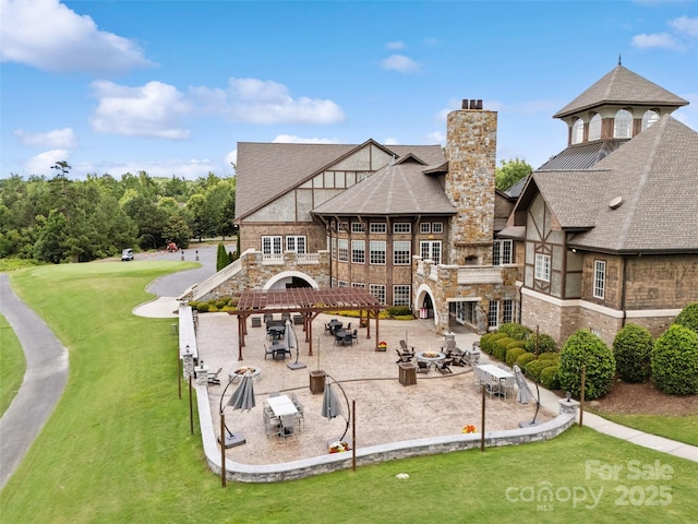 17733 Burnt Hickory Dr, Charlotte, NC 28278 - back of house with a chimney, a patio, stone siding, a gazebo, and a lawn