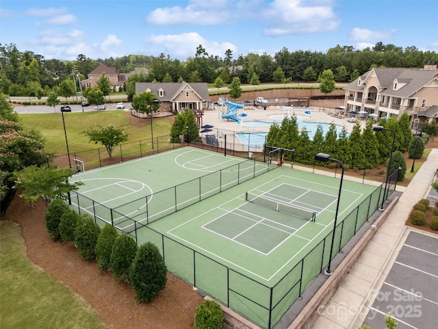 17733 Burnt Hickory Dr, Charlotte, NC 28278 - view of tennis court with a community pool and view of wooded area