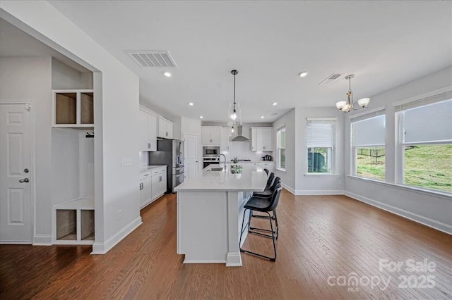 235 Boxelder Rd, Clover, SC 29710 - kitchen with stainless steel appliances, wall chimney range hood, light countertops, white cabinetry, and recessed lighting