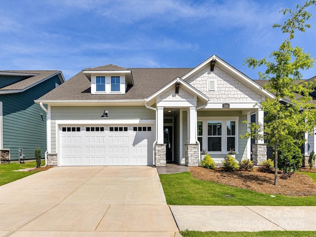 1120 Idyllic Ln, Waxhaw, NC 28173 - craftsman-style home with stone siding, a garage, concrete driveway, and roof with shingles