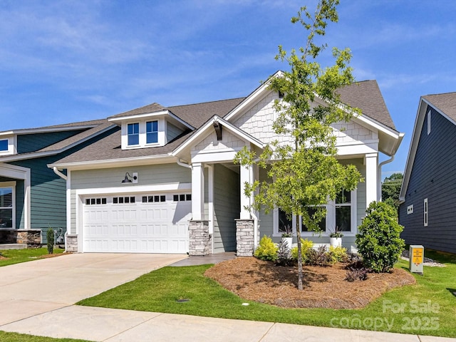1120 Idyllic Ln, Waxhaw, NC 28173 - craftsman house featuring driveway, stone siding, an attached garage, and roof with shingles