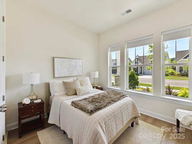 1120 Idyllic Ln, Waxhaw, NC 28173 - bedroom with multiple windows and wood finished floors