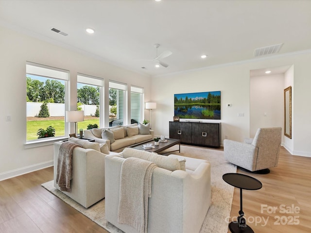 1120 Idyllic Ln, Waxhaw, NC 28173 - living area with ornamental molding, light wood-style floors, ceiling fan, and recessed lighting