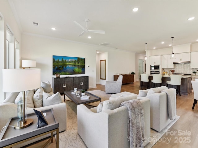 1120 Idyllic Ln, Waxhaw, NC 28173 - living area featuring crown molding, recessed lighting, light wood-style floors, and ceiling fan
