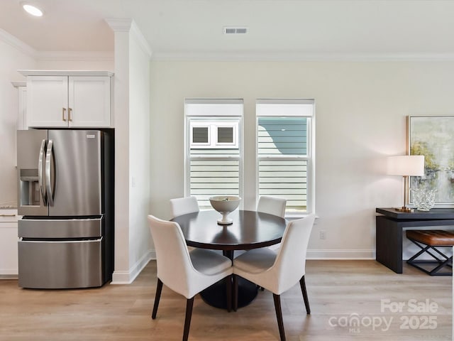 1120 Idyllic Ln, Waxhaw, NC 28173 - dining area with crown molding, light wood-style floors, and recessed lighting