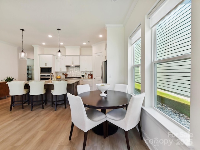1120 Idyllic Ln, Waxhaw, NC 28173 - dining area with crown molding, light wood finished floors, and recessed lighting