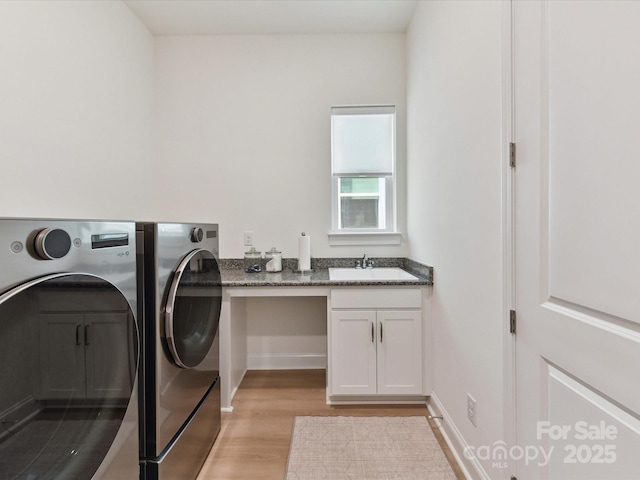 1120 Idyllic Ln, Waxhaw, NC 28173 - laundry room featuring separate washer and dryer, light wood finished floors, and cabinet space