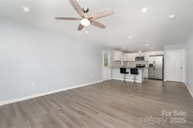 213 Pinewood Dr, Grover, NC 28073 - unfurnished living room featuring a ceiling fan, wood finished floors, and recessed lighting