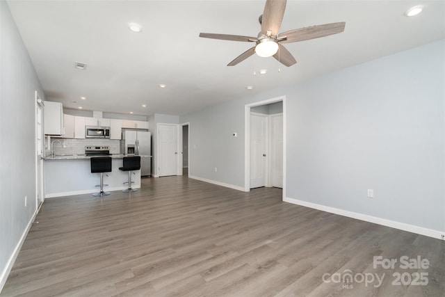 213 Pinewood Dr, Grover, NC 28073 - unfurnished living room featuring recessed lighting, ceiling fan, and wood finished floors