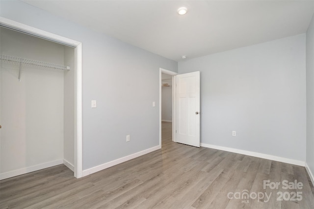 213 Pinewood Dr, Grover, NC 28073 - unfurnished bedroom with light wood-style flooring and a closet