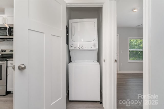 213 Pinewood Dr, Grover, NC 28073 - laundry area featuring stacked washing machine and dryer and light wood-type flooring