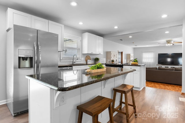 50 Isenhour Park Rd, Taylorsville, NC 28681 - kitchen with stainless steel appliances, a peninsula, healthy amount of natural light, wood finished floors, and recessed lighting