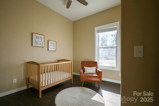 2158 Watson Rd, Lenoir, NC 28645 - bedroom featuring a crib, wood finished floors, and a ceiling fan