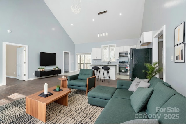 2158 Watson Rd, Lenoir, NC 28645 - living room featuring high vaulted ceiling, light wood finished floors, and a chandelier