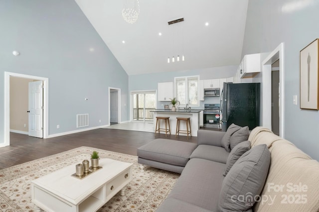 2158 Watson Rd, Lenoir, NC 28645 - living room with high vaulted ceiling and dark wood-type flooring