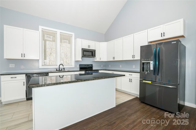 2158 Watson Rd, Lenoir, NC 28645 - kitchen with stainless steel appliances, a center island, white cabinets, and high vaulted ceiling