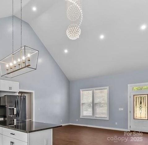 2158 Watson Rd, Lenoir, NC 28645 - unfurnished living room featuring a chandelier, high vaulted ceiling, dark wood finished floors, and recessed lighting