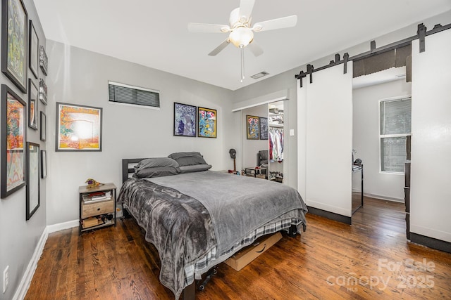 1019 Richard St, Salisbury, NC 28144 - bedroom with a barn door, wood finished floors, and a ceiling fan