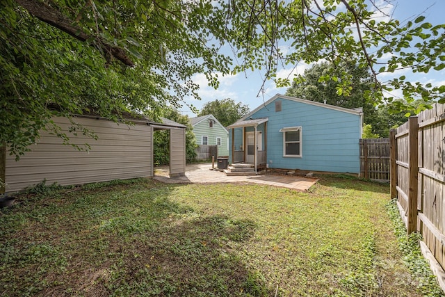 1019 Richard St, Salisbury, NC 28144 - rear view of house featuring a patio area, a fenced backyard, and an outdoor structure