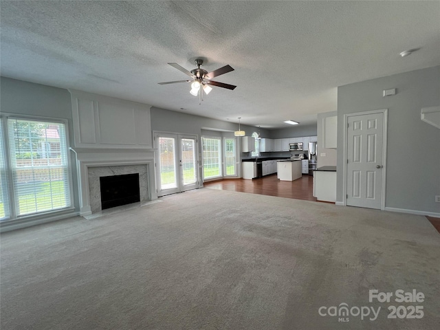 2609 Lamp Post Ln, Kannapolis, NC 28081 - unfurnished living room with a ceiling fan, carpet, a textured ceiling, and a fireplace