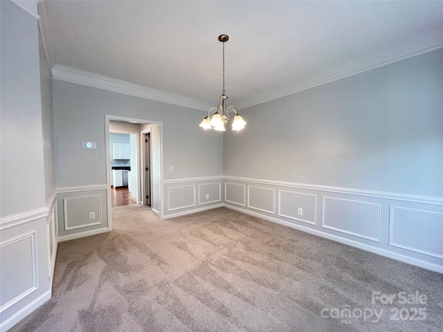 2609 Lamp Post Ln, Kannapolis, NC 28081 - carpeted spare room featuring crown molding, a chandelier, a decorative wall, and a wainscoted wall