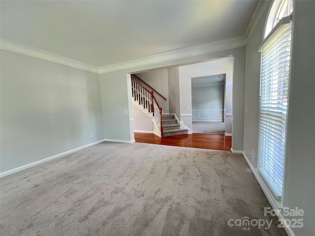 2609 Lamp Post Ln, Kannapolis, NC 28081 - unfurnished living room featuring ornamental molding, carpet, stairway, and healthy amount of natural light