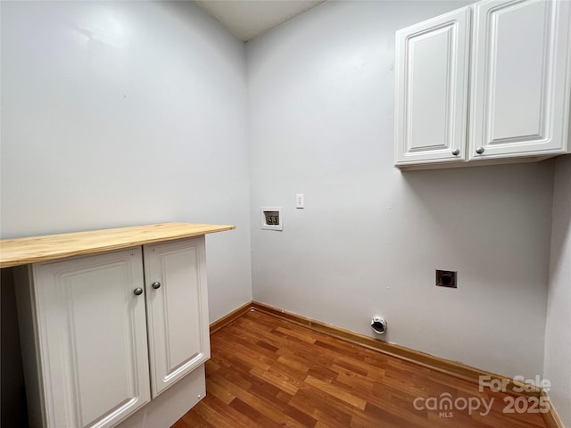 2609 Lamp Post Ln, Kannapolis, NC 28081 - laundry room featuring electric dryer hookup, hookup for a washing machine, wood finished floors, and cabinet space