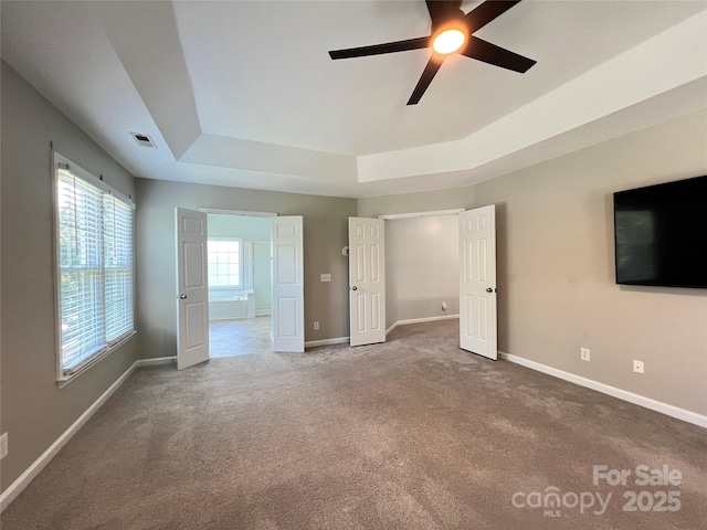 2609 Lamp Post Ln, Kannapolis, NC 28081 - unfurnished bedroom with a raised ceiling, carpet floors, and ceiling fan