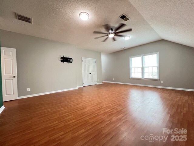 2609 Lamp Post Ln, Kannapolis, NC 28081 - unfurnished room featuring a ceiling fan, wood finished floors, a textured ceiling, and vaulted ceiling