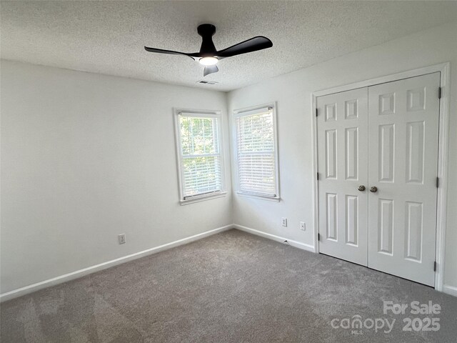 2609 Lamp Post Ln, Kannapolis, NC 28081 - unfurnished bedroom featuring carpet, a closet, a textured ceiling, and a ceiling fan