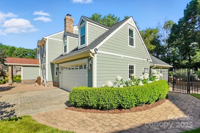 4825 Deanscroft Dr, Charlotte, NC 28226 - view of property exterior featuring a chimney, decorative driveway, and a shingled roof