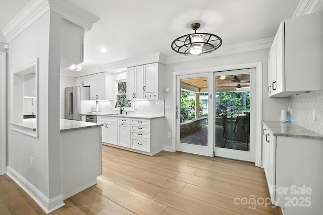 4825 Deanscroft Dr, Charlotte, NC 28226 - kitchen featuring stainless steel appliances, a ceiling fan, crown molding, healthy amount of natural light, and white cabinetry