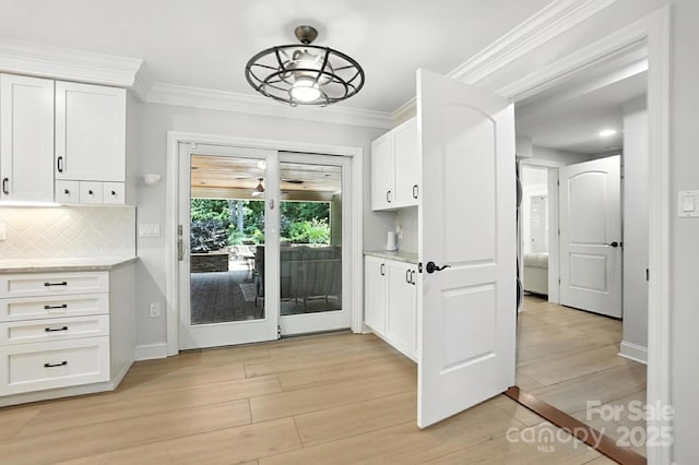 4825 Deanscroft Dr, Charlotte, NC 28226 - doorway with light wood-type flooring, crown molding, and a ceiling fan