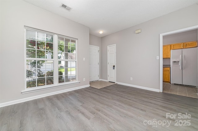 168 Devon Forest Dr, Mooresville, NC 28115 - unfurnished living room featuring light wood finished floors and baseboards