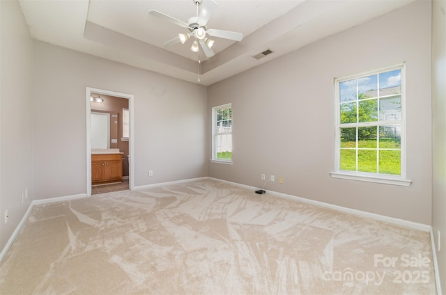168 Devon Forest Dr, Mooresville, NC 28115 - spare room featuring light colored carpet, a ceiling fan, and a raised ceiling