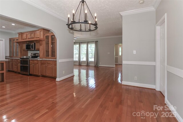 5890 Alley Rd, Catawba, NC 28609 - kitchen with appliances with stainless steel finishes, a chandelier, glass insert cabinets, wood finished floors, and ornamental molding