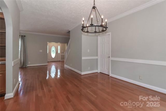 5890 Alley Rd, Catawba, NC 28609 - unfurnished dining area with a chandelier, wood finished floors, a textured ceiling, arched walkways, and ornamental molding