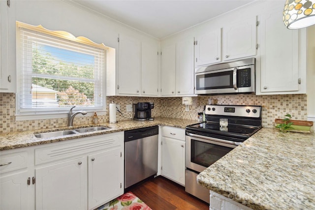 1219 Flowe Dr, Matthews, NC 28104 - kitchen featuring stainless steel appliances, white cabinetry, ornamental molding, dark wood-style floors, and backsplash