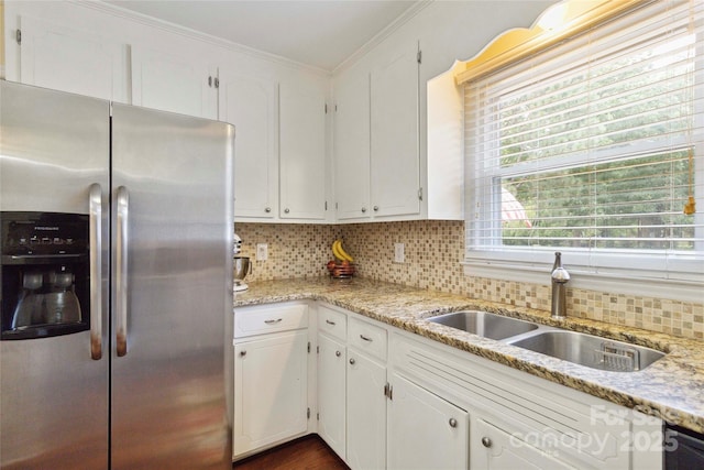1219 Flowe Dr, Matthews, NC 28104 - kitchen with stainless steel fridge, crown molding, backsplash, white cabinetry, and light stone countertops