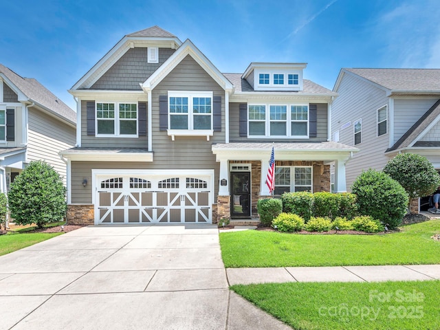 1109 Saratoga Blvd, Indian Trail, NC 28079 - craftsman-style home featuring concrete driveway, an attached garage, a front lawn, stone siding, and a shingled roof