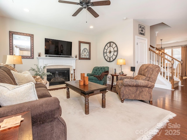 1109 Saratoga Blvd, Indian Trail, NC 28079 - living area with a glass covered fireplace, a ceiling fan, wood finished floors, stairs, and recessed lighting