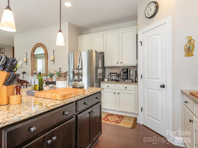 1109 Saratoga Blvd, Indian Trail, NC 28079 - kitchen with freestanding refrigerator, dark wood-style floors, dark brown cabinetry, white cabinets, and hanging light fixtures