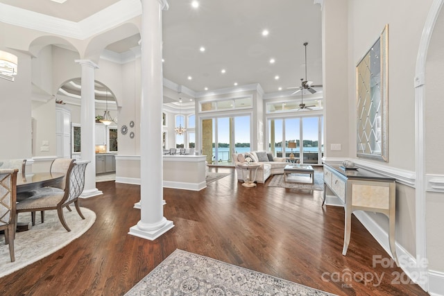 3394 Governors Island Dr, Denver, NC 28037 - entrance foyer with decorative columns, crown molding, a ceiling fan, wood finished floors, and arched walkways