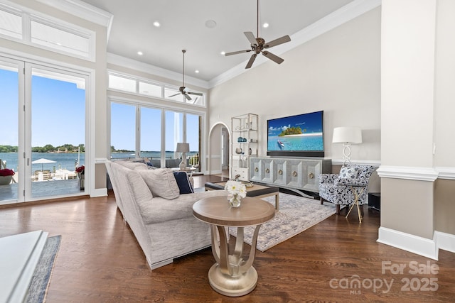3394 Governors Island Dr, Denver, NC 28037 - living area featuring a ceiling fan, arched walkways, a towering ceiling, healthy amount of natural light, and crown molding