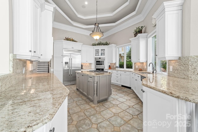 3394 Governors Island Dr, Denver, NC 28037 - kitchen featuring stainless steel appliances, light stone counters, white cabinetry, and ornamental molding