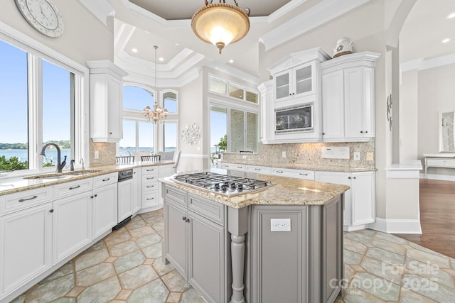 3394 Governors Island Dr, Denver, NC 28037 - kitchen featuring stainless steel gas cooktop, white cabinets, ornamental molding, decorative backsplash, and glass insert cabinets