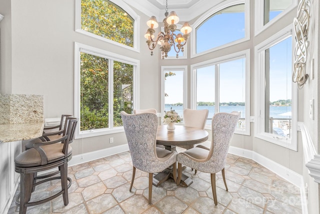 3394 Governors Island Dr, Denver, NC 28037 - dining room with a water view, a chandelier, ornamental molding, and a towering ceiling