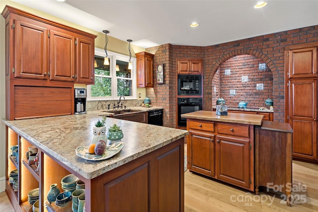 62 Skyline Dr Unit 509-510, Old Fort, NC 28762 - kitchen with black appliances, open shelves, light wood-style flooring, a peninsula, and brick wall