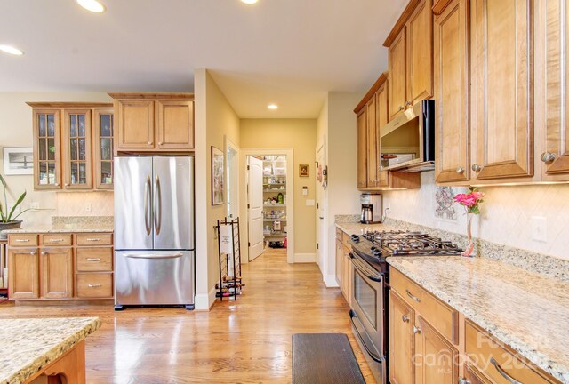 35 Village Pointe Ln, Asheville, NC 28803 - kitchen with stainless steel appliances, decorative backsplash, light wood-type flooring, recessed lighting, and glass insert cabinets